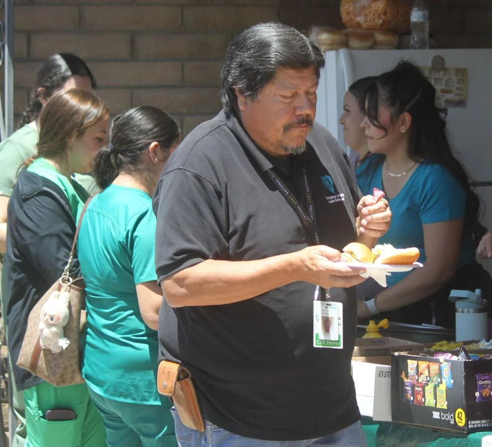 Gene Trujillo, an employee in Douglas, has his hamburger and hot dog buns prepared Tuesday in Douglas. Bruce Whetten Herald/Review